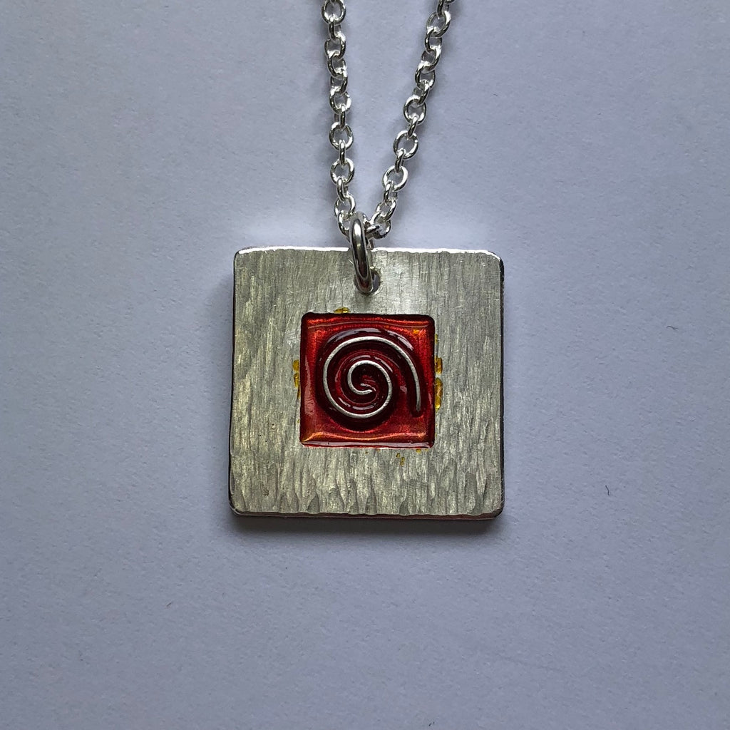 Koru pendant with red cloisonne enamel